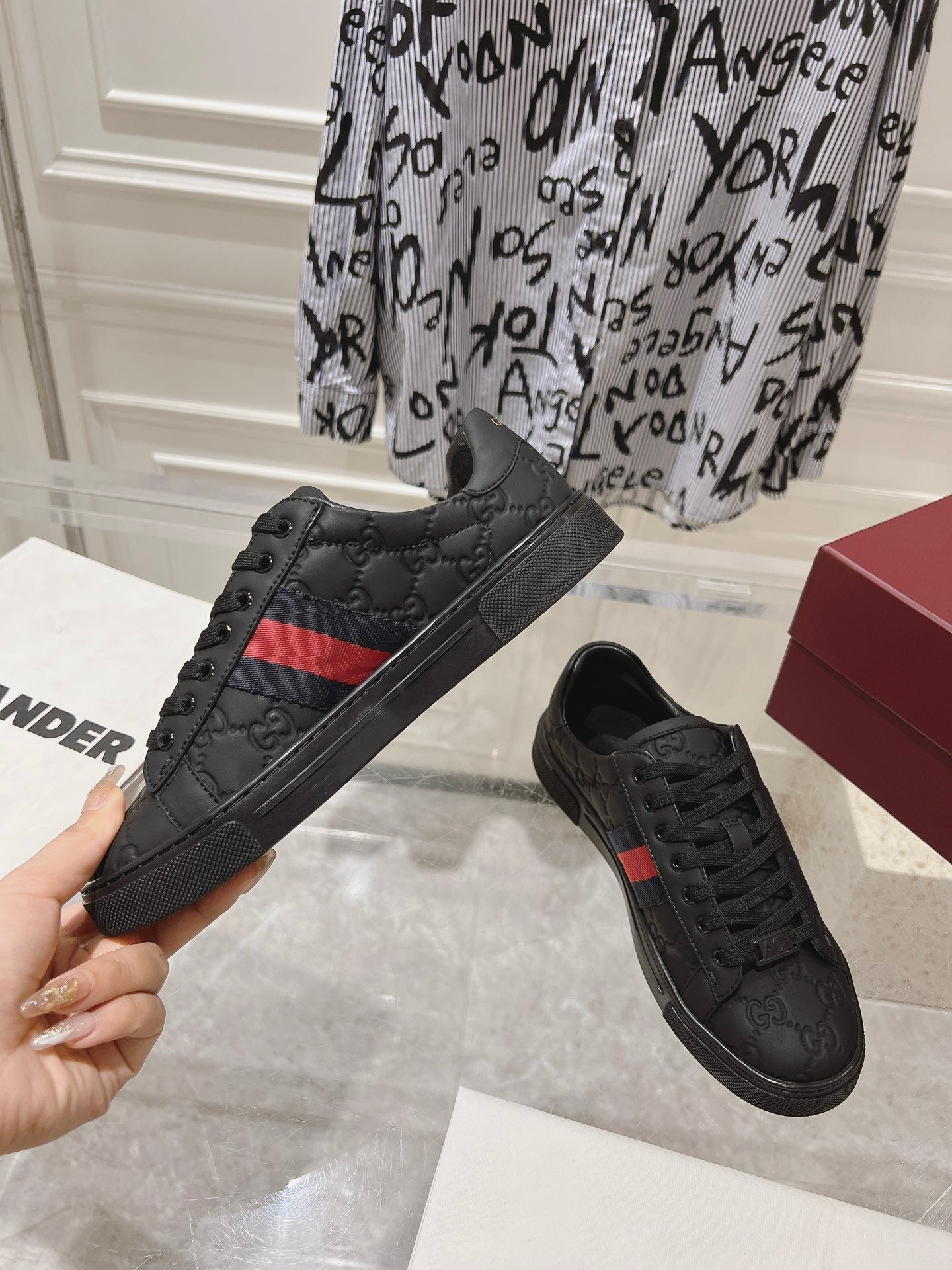 Luxury Black Sneakers with Red Signature Stripe