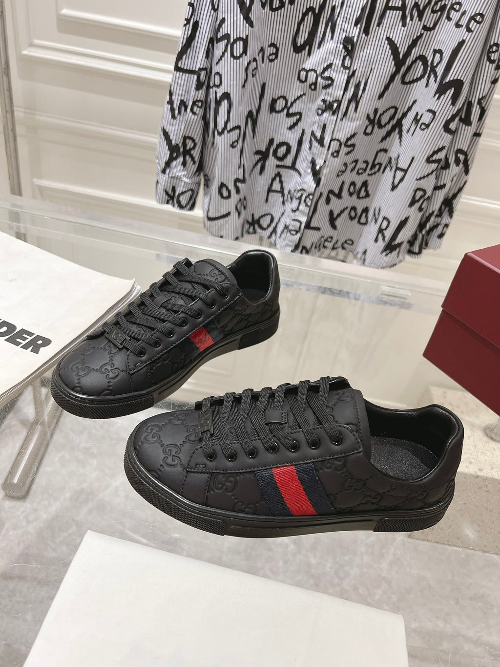 Luxury Black Sneakers with Red Signature Stripe