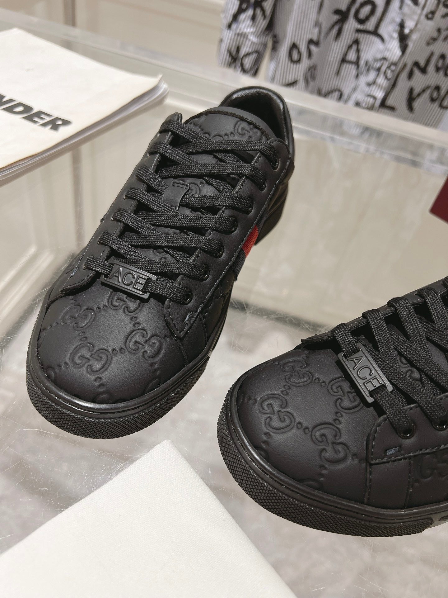 Luxury Black Monogram Sneakers with Red Signature Stripe